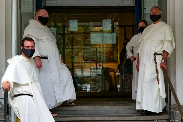 A photo of four priests wearing masks in Manhattan